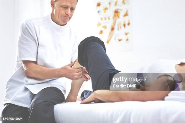 shot of a client having her calf massaged by her physiotherapist - calf human leg stock pictures, royalty-free photos & images