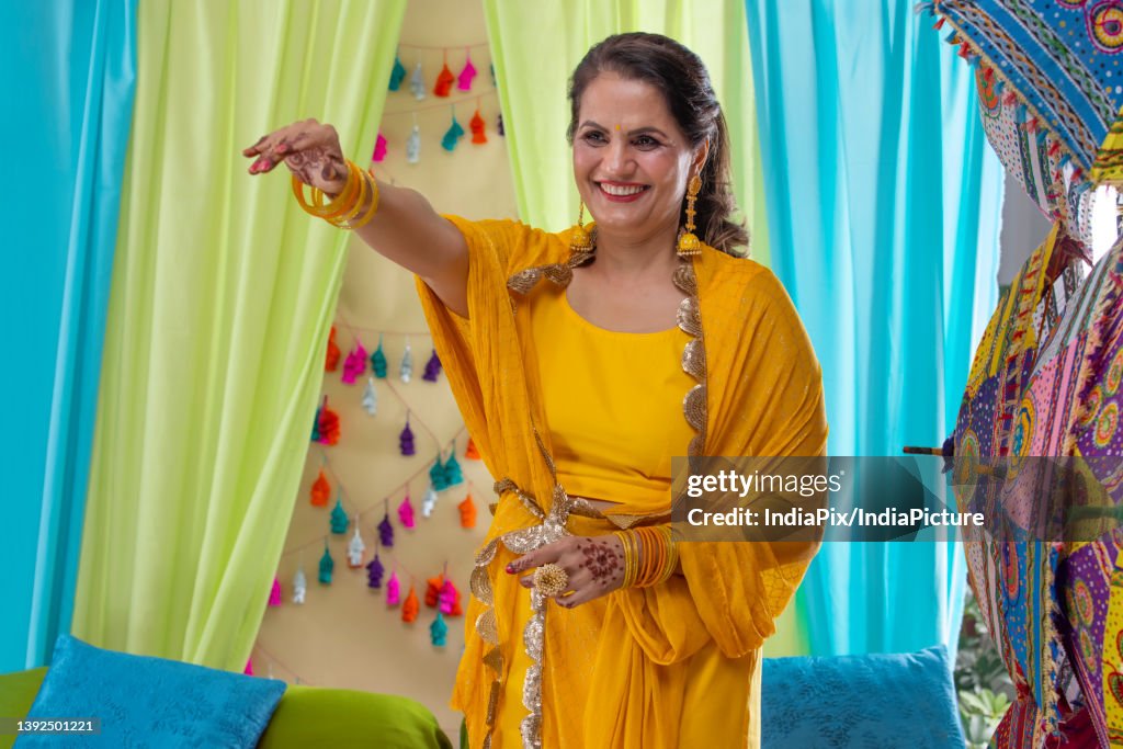 A portrait of an Indian mother during her daughter's haldi ceremony