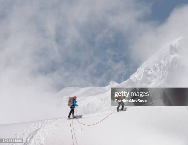 mountaineering teamwork - crampon stockfoto's en -beelden