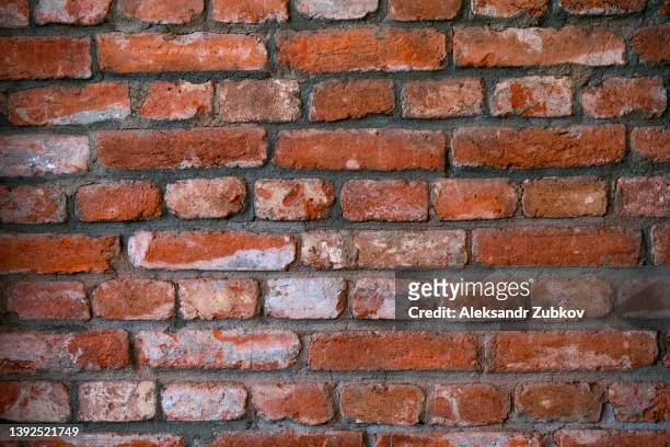 red or brown wall. the facade of the building with old plaster. abstract banner. brickwork. background. texture. - cracked foundation stock pictures, royalty-free photos & images
