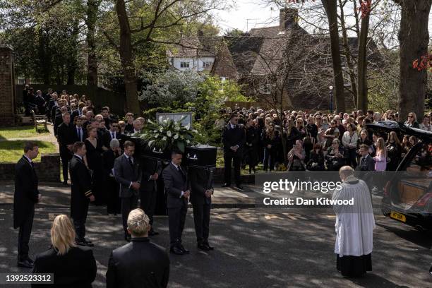 The coffin is carried from St Francis of Assisi church and lowered into a hearse following a funeral service for Tom Parker on April 20, 2022 in...