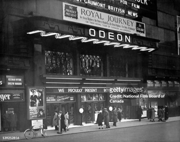 Exterior view of the Odeon Theatre in Leicester Square where the NFB film 'Royal Journey' is being shown, London, England, 1952. Photo taken during...
