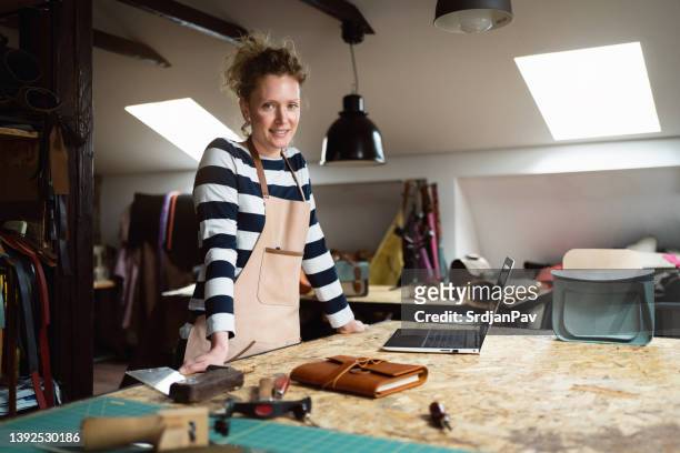 portrait of proud female fashion designer at workshop - leather notebook stock pictures, royalty-free photos & images