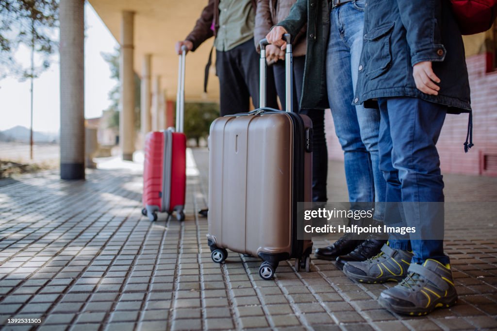 Low section of Ukrainian refugee family in station waiting to leave Ukraine due to the Russian invasion of Ukraine.