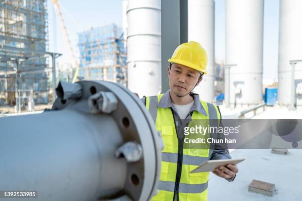 a male safety officer is checking the safety of the equipment - asian architect 40 imagens e fotografias de stock