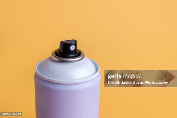 aerosol spray can on yellow background - aerosol stock pictures, royalty-free photos & images