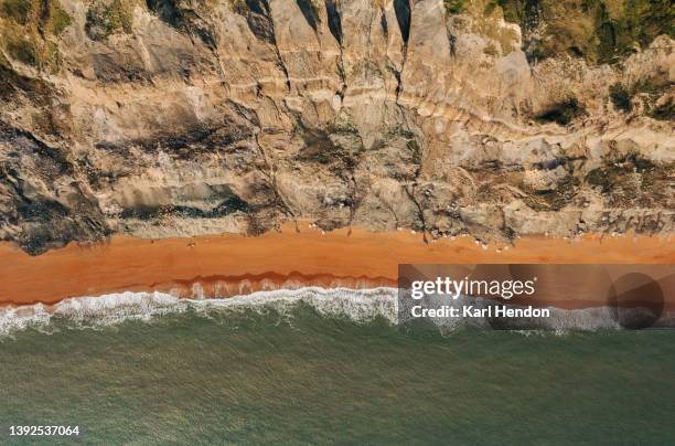 an aerial view daytime view of waves on a  beach - jurásico fotografías e imágenes de stock