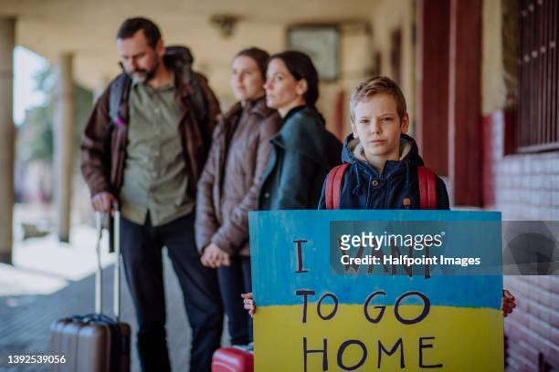 ukrainian refugee family in station waiting to leave ukraine due to the russian invasion of ukraine. - displaced stock pictures, royalty-free photos & images