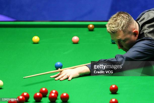 Kyren Wilson of England plays a shot in the first round match against Ding Junhui of China on day five of the 2022 Betfred World Snooker Championship...