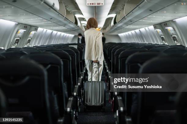 businesswoman traveling on an airplane to a business destination - commercial aviation foto e immagini stock