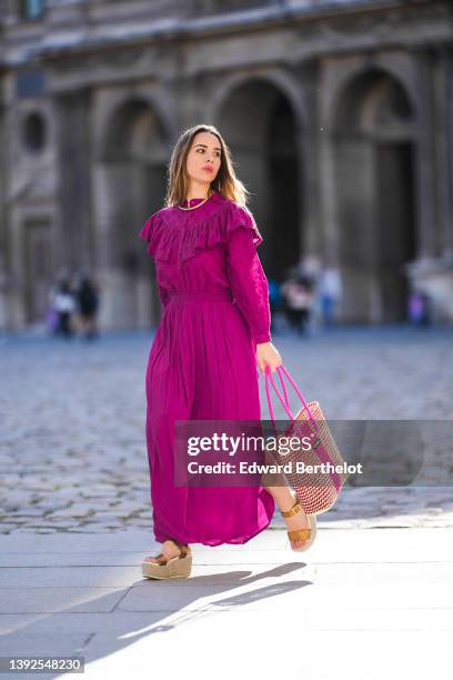 Maria Rosaria Rizzo @lacoquetteitalienne wears a gold large snake pattern necklace, a matching gold snake print pattern bracelet, a purple high neck...