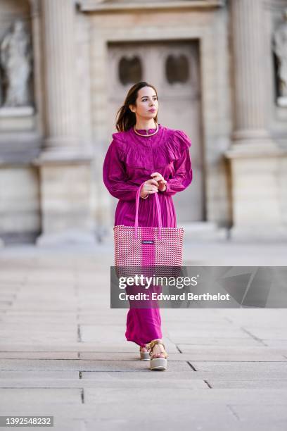 Maria Rosaria Rizzo @lacoquetteitalienne wears a gold large snake pattern necklace, a matching gold snake print pattern bracelet, a purple high neck...