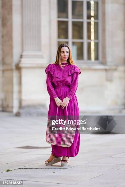 Maria Rosaria Rizzo @lacoquetteitalienne wears a gold large snake pattern necklace, a matching gold snake print pattern bracelet, a purple high neck...