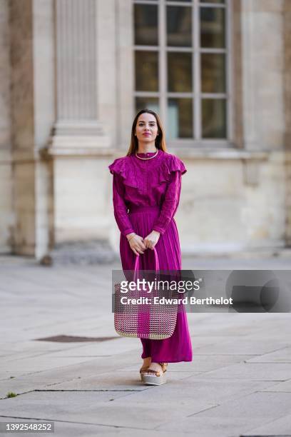 Maria Rosaria Rizzo @lacoquetteitalienne wears a gold large snake pattern necklace, a matching gold snake print pattern bracelet, a purple high neck...