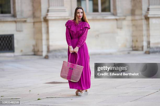 Maria Rosaria Rizzo @lacoquetteitalienne wears a gold large snake pattern necklace, a matching gold snake print pattern bracelet, a purple high neck...