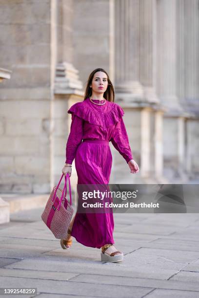 Maria Rosaria Rizzo @lacoquetteitalienne wears a gold large snake pattern necklace, a matching gold snake print pattern bracelet, a purple high neck...