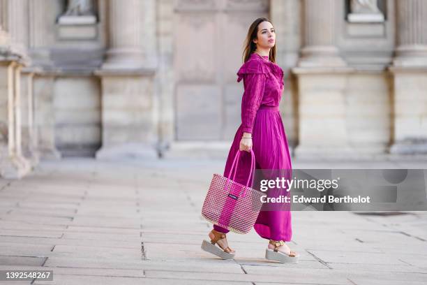 Maria Rosaria Rizzo @lacoquetteitalienne wears a gold large snake pattern necklace, a matching gold snake print pattern bracelet, a purple high neck...