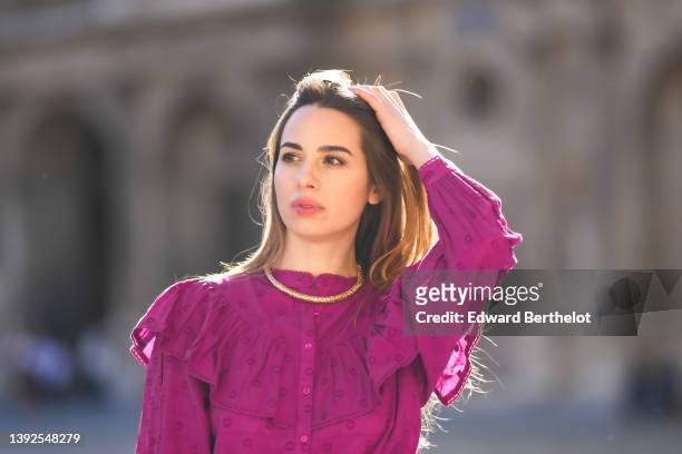 Maria Rosaria Rizzo @lacoquetteitalienne wears a gold large snake pattern necklace, a purple high neck / ruffled shoulder / long sleeves / belted...