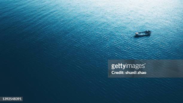 aerial view of a fishing boat in open ocean - small boat ocean fotografías e imágenes de stock