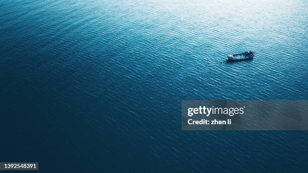 aerial view of a fishing boat in open ocean - recreational boat stock pictures, royalty-free photos & images