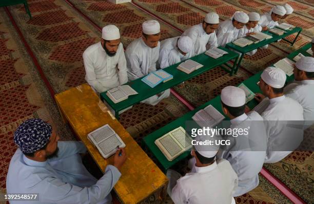 Kashmiri Muslim students of a Madrasa, Islamic religious school, recite the holy Koran during the month of Ramadan in Srinagar, Kashmir. Muslims...