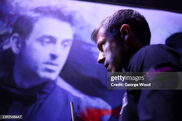 Jack Lisowski of England takes to the arena floor past an image of Ronnie O'Sullivan during the Betfred World Snooker Championship Round One match...