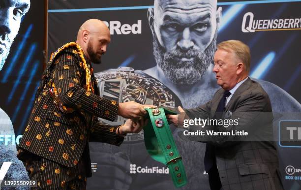 Promoter Frank Warren hands over the WBC belt to Tyson Fury during a press conference ahead of the heavyweight boxing match between Tyson Fury and...