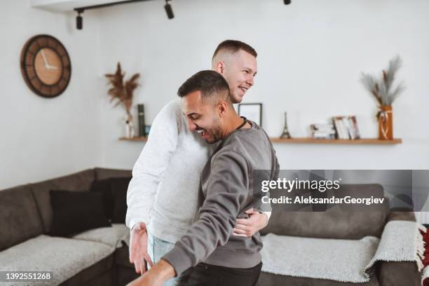 gay males dancing together at home - couple dancing at home stock pictures, royalty-free photos & images