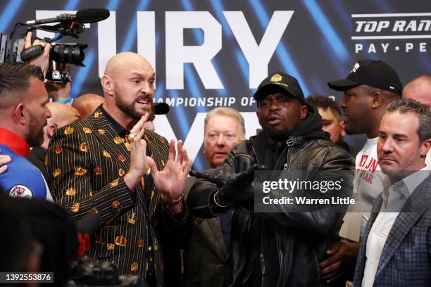 Tyson Fury and Dillian Whyte interact during a press conference ahead of the heavyweight boxing match between Tyson Fury and Dillian Whyte at Wembley...