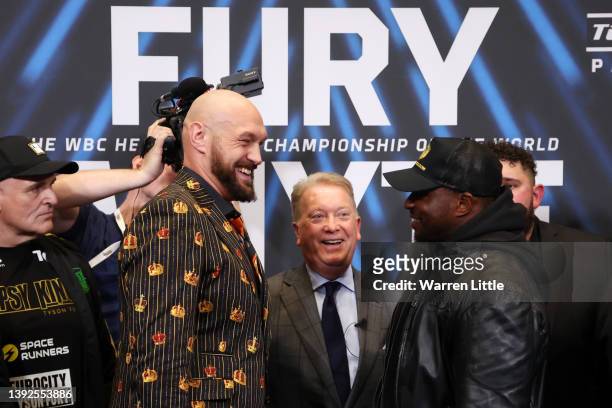 Tyson Fury, promoter Frank Warren and Dillian Whyte interact during a press conference ahead of the heavyweight boxing match between Tyson Fury and...