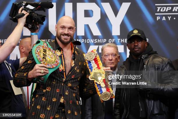 Tyson Fury, promoter Frank Warren and Dillian Whyte pose for a photo during a press conference ahead of the heavyweight boxing match between Tyson...