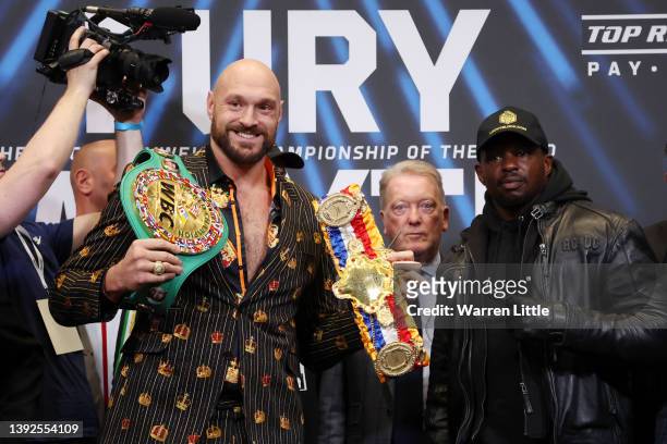 Tyson Fury, promoter Frank Warren and Dillian Whyte pose for a photo during a press conference ahead of the heavyweight boxing match between Tyson...