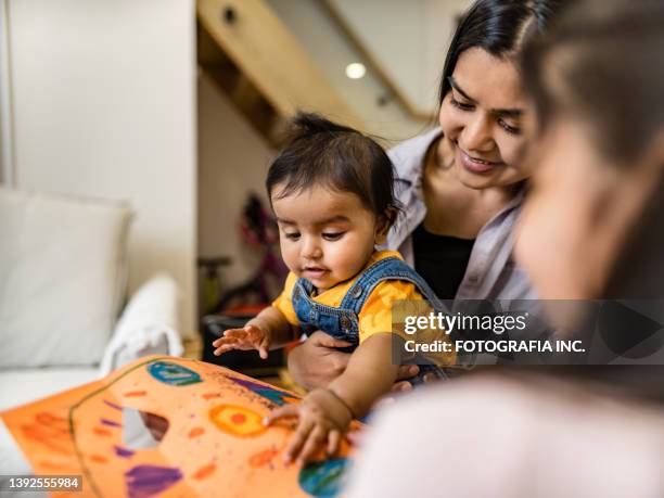 east indian mother and two young children playing - 6 11 maanden stockfoto's en -beelden