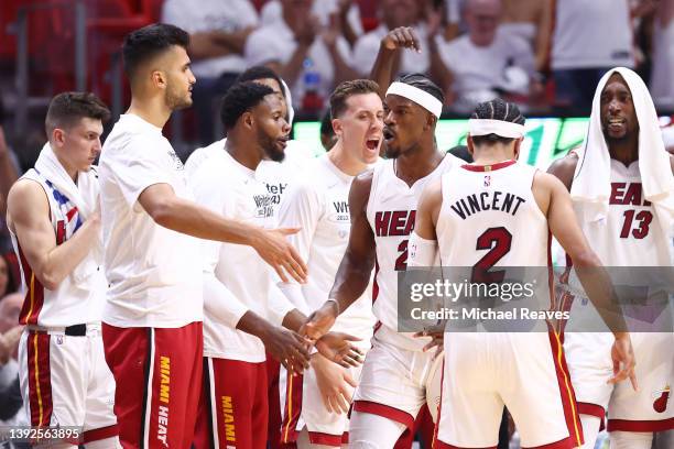Jimmy Butler of the Miami Heat celebrates with teammates after a foul and a basket against the Atlanta Hawks during the first half in Game Two of the...
