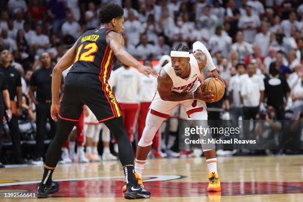 Jimmy Butler of the Miami Heat is defended by De'Andre Hunter of the Atlanta Hawks during the second half in Game Two of the Eastern Conference First...