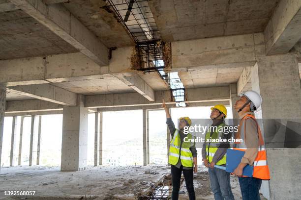three asian engineers working on construction site - three storey stock pictures, royalty-free photos & images
