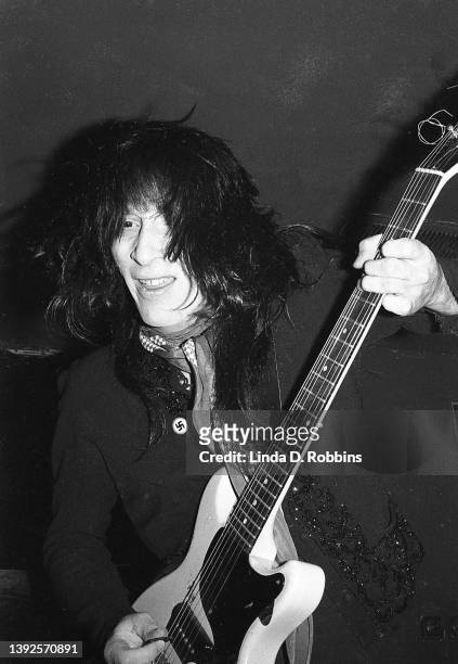 Guitarist Johnny Thunders plays with the New York Dolls at Max's Kansas City in New York, August 1973. He wears a swastika badge on his lapel.