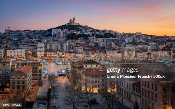 evening mood,high angle view of buildings in city at sunset,marseille,france - marseille stock-fotos und bilder