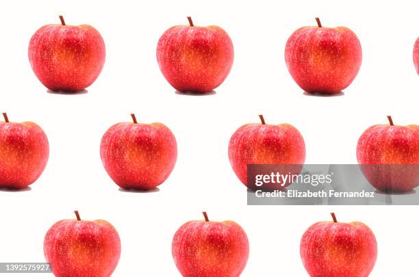 seamless pattern of red apple on white background - apple white background stock-fotos und bilder