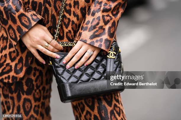 Gabriella Berdugo wears a brown and black shiny leather snake print pattern blazer jacket, matching brown and black shiny leather snake print pattern...