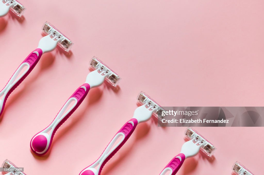 Seamless pattern of disposable razor on pink background. Copy space on image