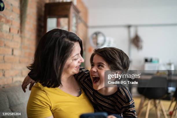 mother and son embracing at home - mom cheering stock pictures, royalty-free photos & images