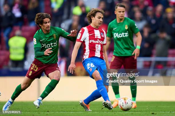 Víctor Mollejo of Atletico de Madrid battle for the ball with Alex Collado of Granada CF during the LaLiga Santander match between Club Atletico de...