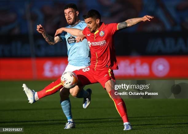 Javi Galan of RC Celta de Vigo is challenged by Mauro Arambarri of Getafe during the LaLiga Santander match between RC Celta de Vigo and Getafe CF at...