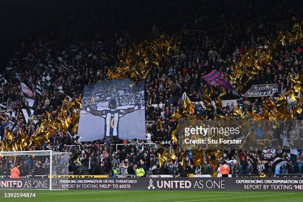Fans of Newcastle United display flags in support of Allan Saint-Maximin of Newcastle United prior to the Premier League match between Newcastle...