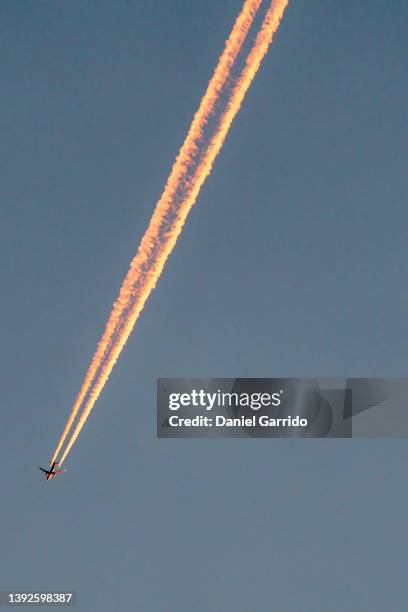 flying plane and its wake. aircraft background. space rocket.travel and vacation - rocket engine stock pictures, royalty-free photos & images