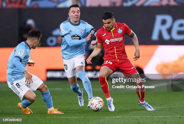 Mauro Arambarri of Getafe is challenged by Iago Aspas of RC Celta de Vigo during the LaLiga Santander match between RC Celta de Vigo and Getafe CF at...