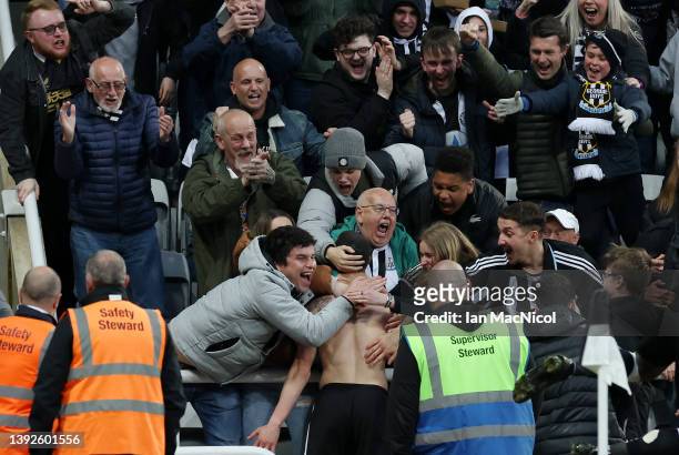 Miguel Almiron of Newcastle United celebrates after scoring their side's first goal with the fans during the Premier League match between Newcastle...