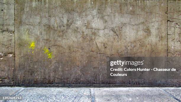 very old dark and weathered stone wall with sidewalk in paris - ugly wallpaper stock pictures, royalty-free photos & images