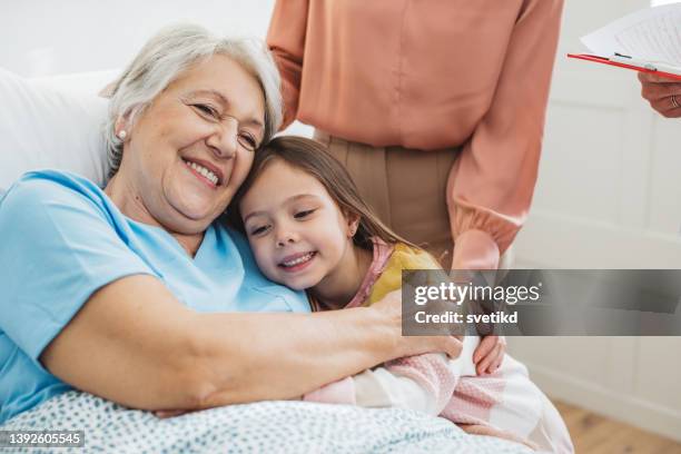 visiting  grandmother at hospital - care home bed stock pictures, royalty-free photos & images